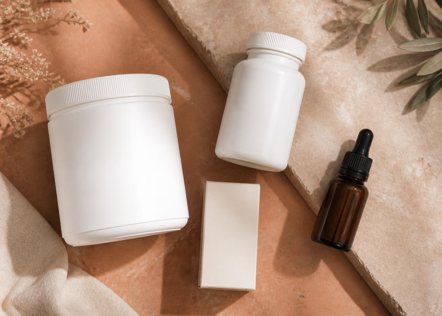 Flat-lay of creatine, magnesium, probiotic and vitamin D supplements
